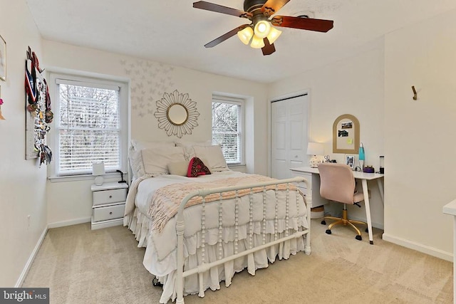 bedroom with carpet flooring, baseboards, a closet, and a ceiling fan