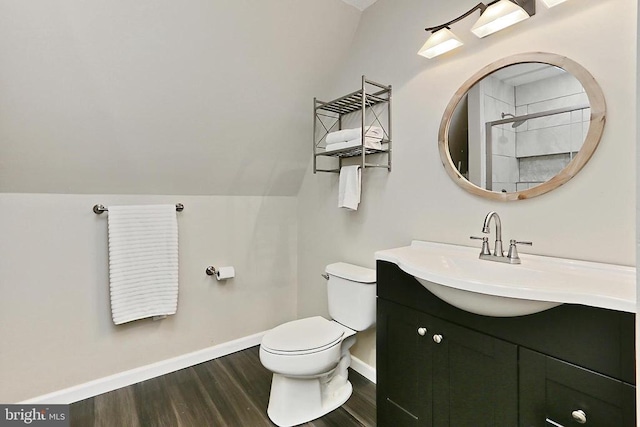 bathroom with toilet, wood finished floors, a shower, baseboards, and vanity