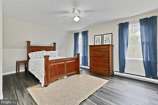 bedroom with a textured ceiling, baseboard heating, ceiling fan, and dark wood-style floors