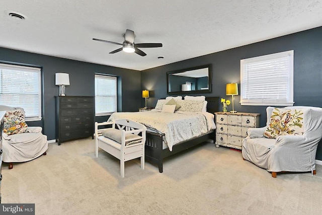 bedroom featuring a ceiling fan, carpet floors, baseboards, and visible vents