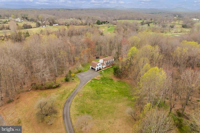 drone / aerial view featuring a forest view