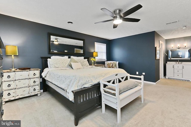 bedroom with carpet, a ceiling fan, a sink, visible vents, and baseboards