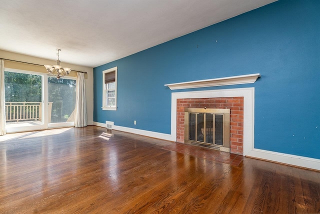 340 New York Ave, Harrisonburg, VA 22801 - unfurnished living room featuring a chandelier, wood finished floors, and a fireplace