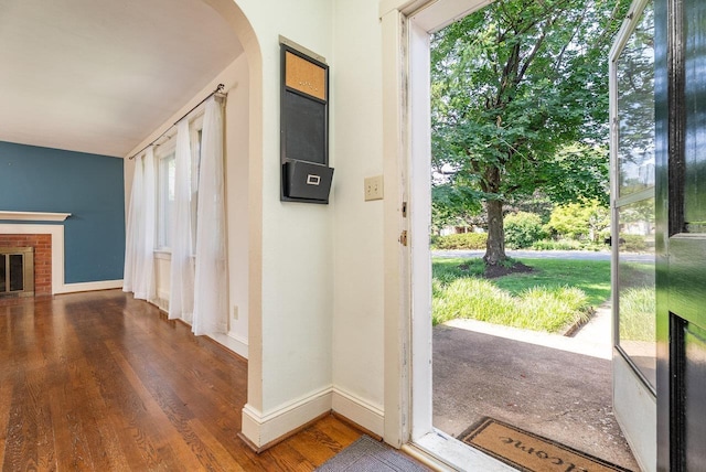 340 New York Ave, Harrisonburg, VA 22801 - foyer entrance with wood finished floors, arched walkways, and a brick fireplace