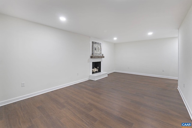 102 Powhatan Cir, Charlottesville, VA 22901 - unfurnished living room with a large fireplace, recessed lighting, dark wood-style flooring, and baseboards