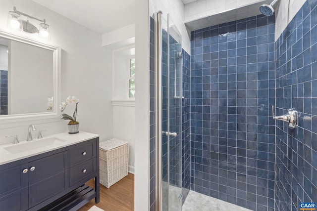 102 Powhatan Cir, Charlottesville, VA 22901 - bathroom with wood finished floors, a tile shower, and vanity