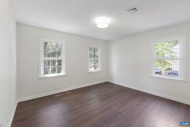 102 Powhatan Cir, Charlottesville, VA 22901 - empty room featuring dark wood-type flooring, healthy amount of natural light, and baseboards