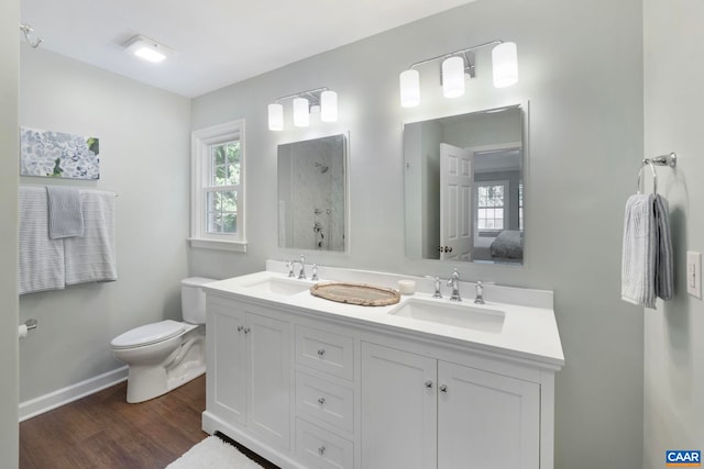 102 Powhatan Cir, Charlottesville, VA 22901 - full bathroom featuring a shower, double vanity, toilet, wood finished floors, and baseboards