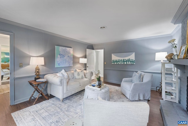 102 Powhatan Cir, Charlottesville, VA 22901 - living area with wood finished floors, crown molding, a fireplace with raised hearth, and baseboards