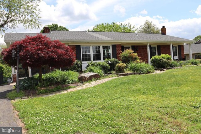 rear view of property with a yard, a chimney, a gazebo, and a deck