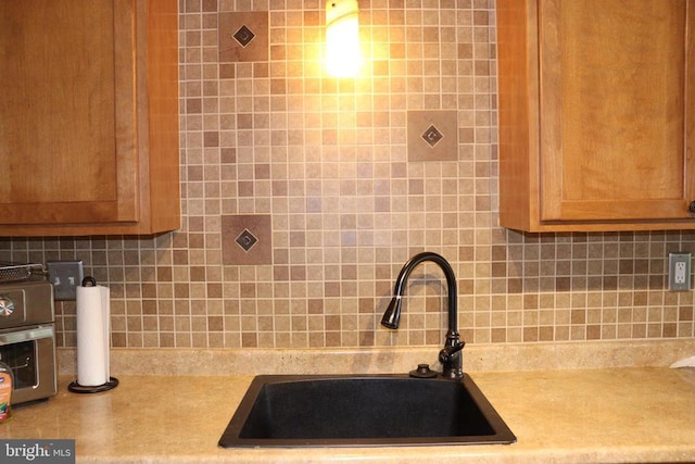 229 Dover Rd, Warrenton, VA 20186 - kitchen featuring backsplash, light countertops, and brown cabinetry