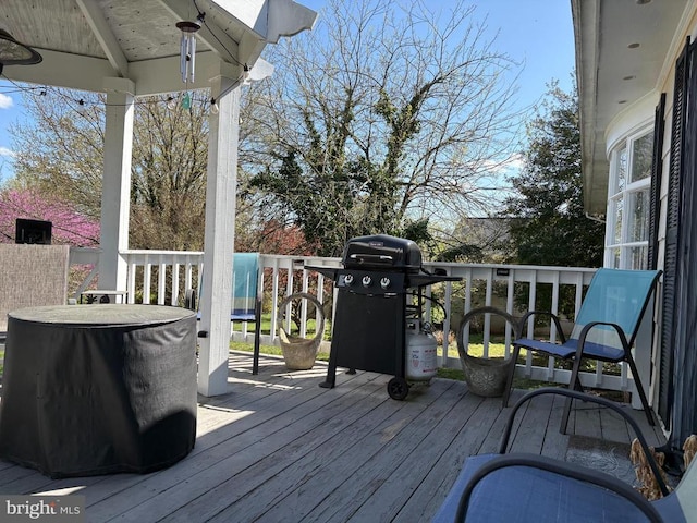 wooden terrace featuring a grill