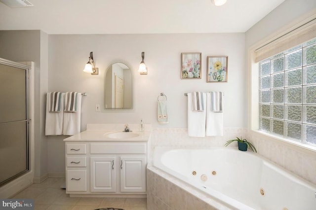 full bathroom with a whirlpool tub, a stall shower, vanity, and tile patterned flooring