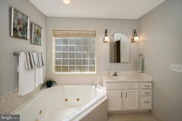 full bath with a whirlpool tub, vanity, and tile patterned flooring