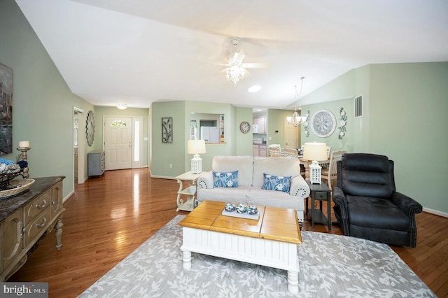 living area featuring wood finished floors, a ceiling fan, and baseboards