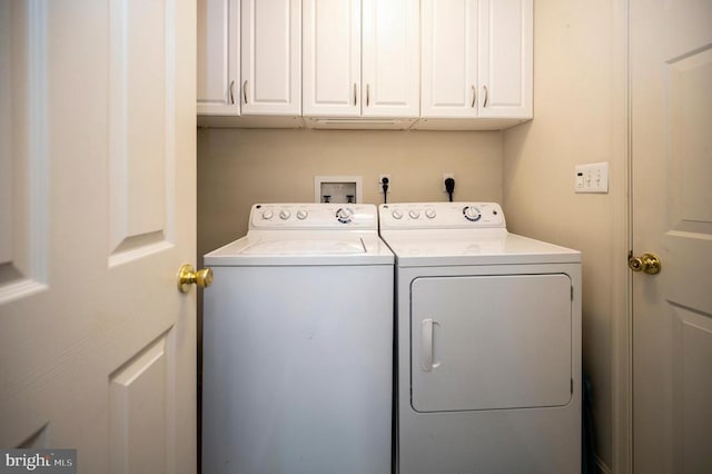 laundry area with washer and dryer and cabinet space