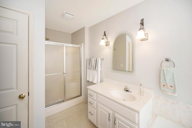 full bath with a shower stall and vanity