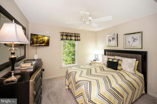 carpeted bedroom featuring baseboards and a ceiling fan