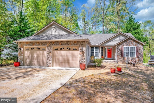 ranch-style home with stone siding, a garage, and concrete driveway