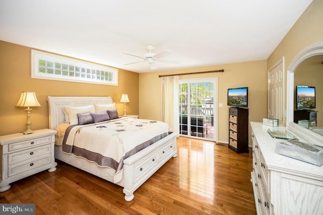 bedroom with access to outside, hardwood / wood-style floors, and ceiling fan