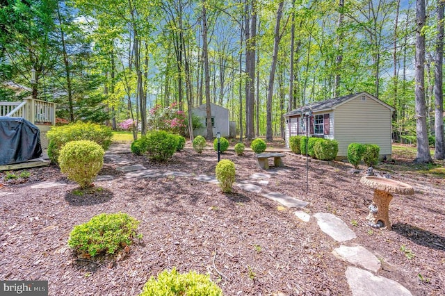 view of yard featuring an outbuilding and a wooden deck