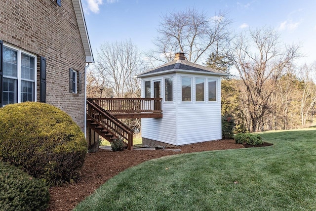 exterior space with stairs and a lawn