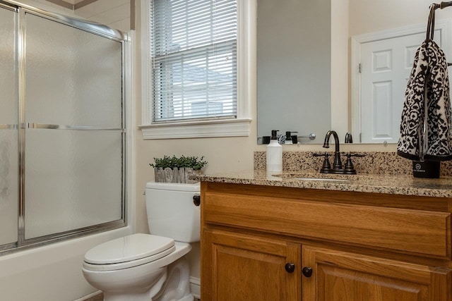 full bathroom with toilet, vanity, and combined bath / shower with glass door