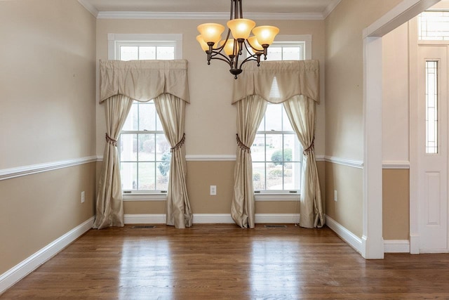 interior space featuring a chandelier, crown molding, and wood finished floors