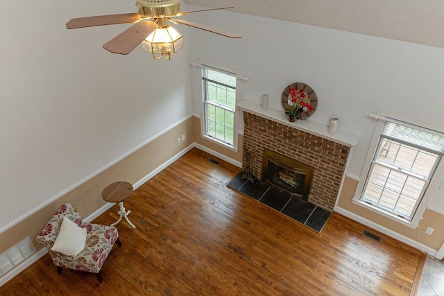 living area with visible vents and wood finished floors
