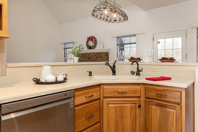 kitchen featuring lofted ceiling, dishwasher, brown cabinetry, a sink, and light countertops