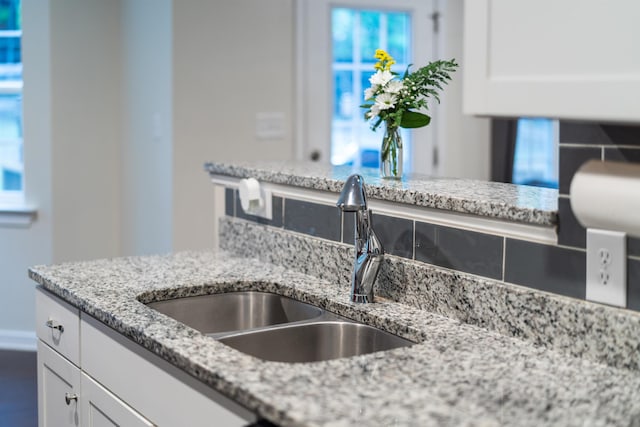 10 Zephyr Rd, Palmyra, VA 22963 - kitchen view of a sink, white cabinetry, and light stone counters