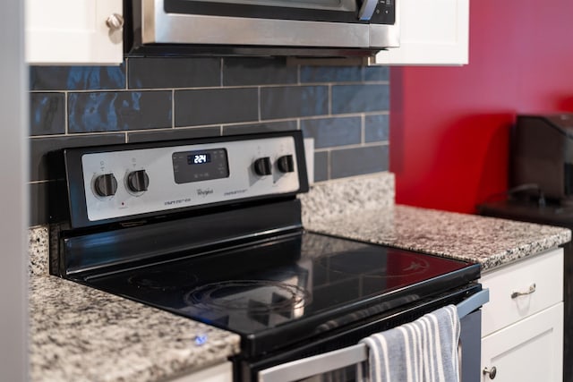 10 Zephyr Rd, Palmyra, VA 22963 - kitchen featuring appliances with stainless steel finishes, white cabinetry, decorative backsplash, and light stone counters