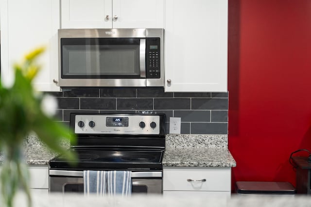 10 Zephyr Rd, Palmyra, VA 22963 - kitchen view of stainless steel appliances, white cabinets, backsplash, and light stone countertops