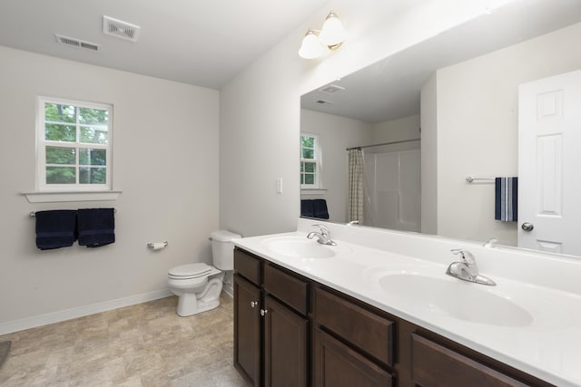 10 Zephyr Rd, Palmyra, VA 22963 - full bathroom featuring double vanity, baseboards, healthy amount of natural light, and toilet