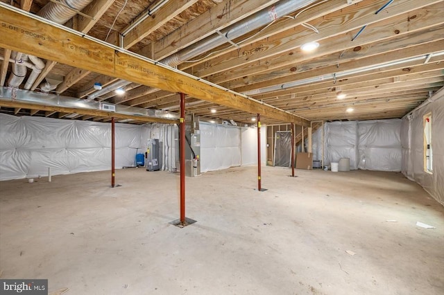 unfinished basement featuring water heater