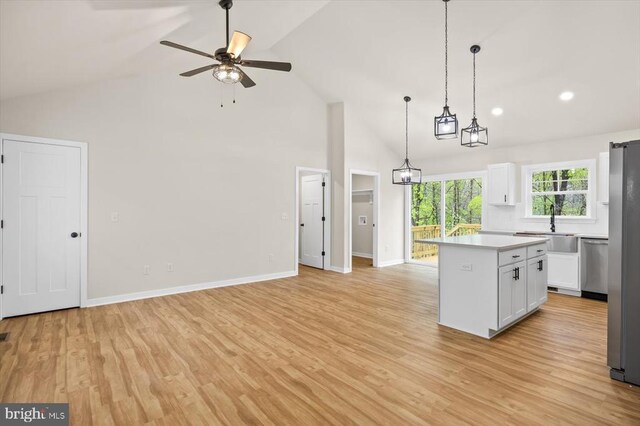 kitchen with dishwasher, a sink, white cabinetry, light countertops, and a ceiling fan