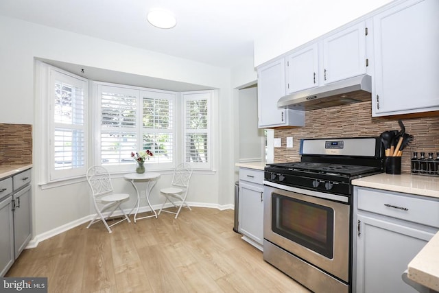769 Cherry Tree Ln, Warrenton, VA 20186 - kitchen featuring stainless steel range with gas cooktop, under cabinet range hood, backsplash, and healthy amount of natural light