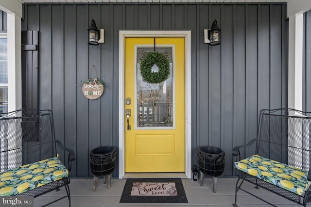 view of exterior entry featuring board and batten siding