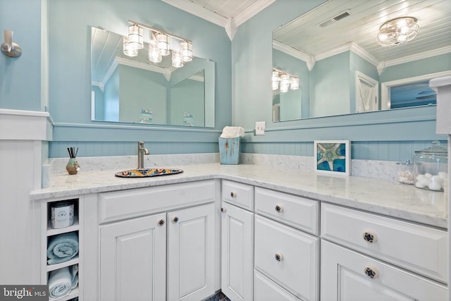 bathroom featuring ornamental molding, visible vents, and vanity