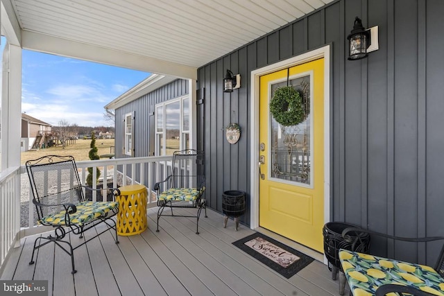 property entrance with a porch and board and batten siding