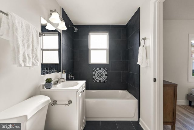 full bathroom with tile patterned flooring, plenty of natural light, bathing tub / shower combination, and vanity