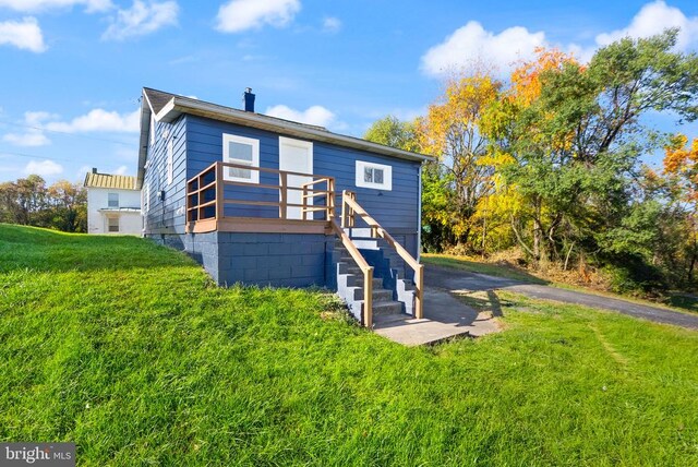 back of house featuring stairs and a yard