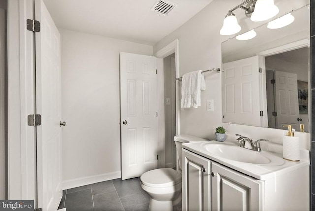 bathroom with visible vents, toilet, vanity, baseboards, and tile patterned floors