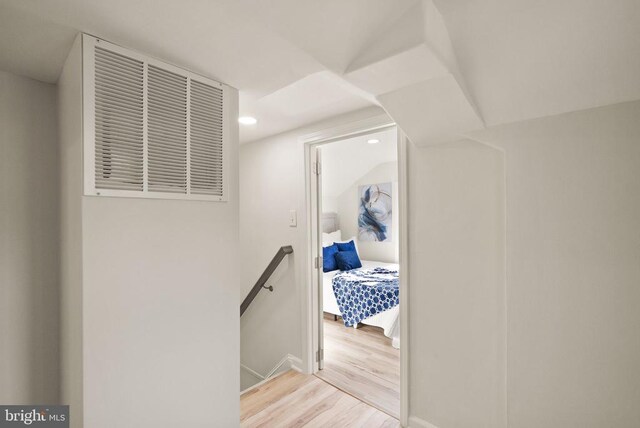 hall with recessed lighting, baseboards, an upstairs landing, and wood finished floors