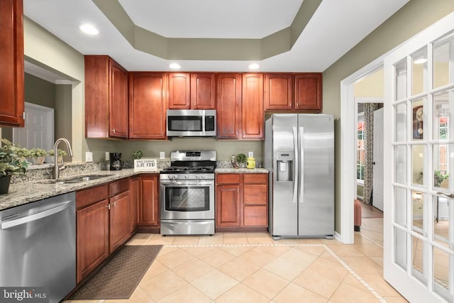 12006 Meadow Branch Way, Fredericksburg, VA 22407 - kitchen featuring appliances with stainless steel finishes, light stone counters, recessed lighting, light tile patterned floors, and a tray ceiling