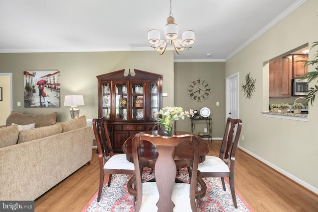 12006 Meadow Branch Way, Fredericksburg, VA 22407 - dining room with a chandelier, light wood-style flooring, and crown molding