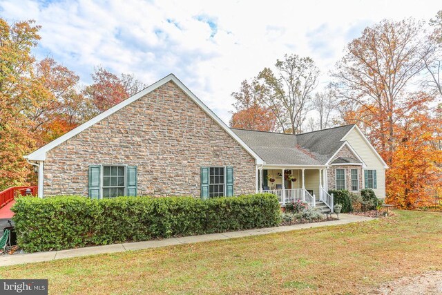 5519 Bazzanella Dr, Mineral, VA 23117 - ranch-style home featuring covered porch, stone siding, and a front lawn