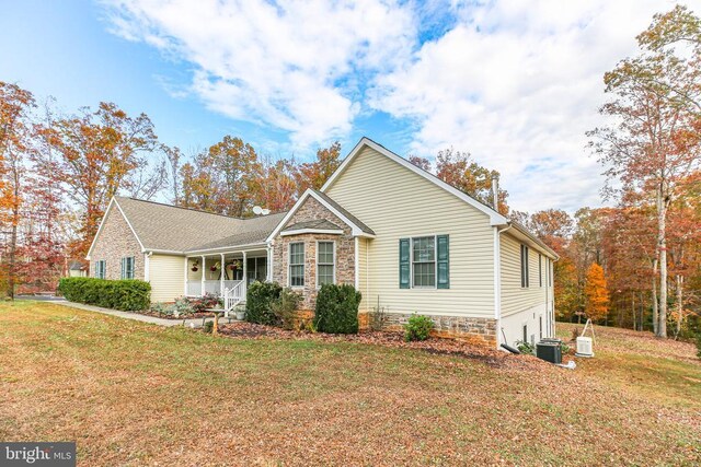 5519 Bazzanella Dr, Mineral, VA 23117 - view of front of house featuring central air condition unit, a front lawn, a porch, and stone siding