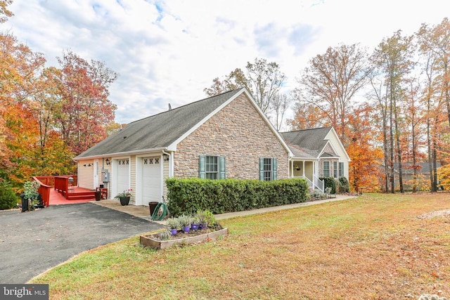 5519 Bazzanella Dr, Mineral, VA 23117 - view of front of home featuring stone siding, driveway, a garage, a front lawn, and a deck