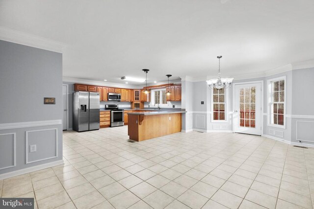5519 Bazzanella Dr, Mineral, VA 23117 - kitchen with stainless steel appliances, a decorative wall, crown molding, a chandelier, and a peninsula